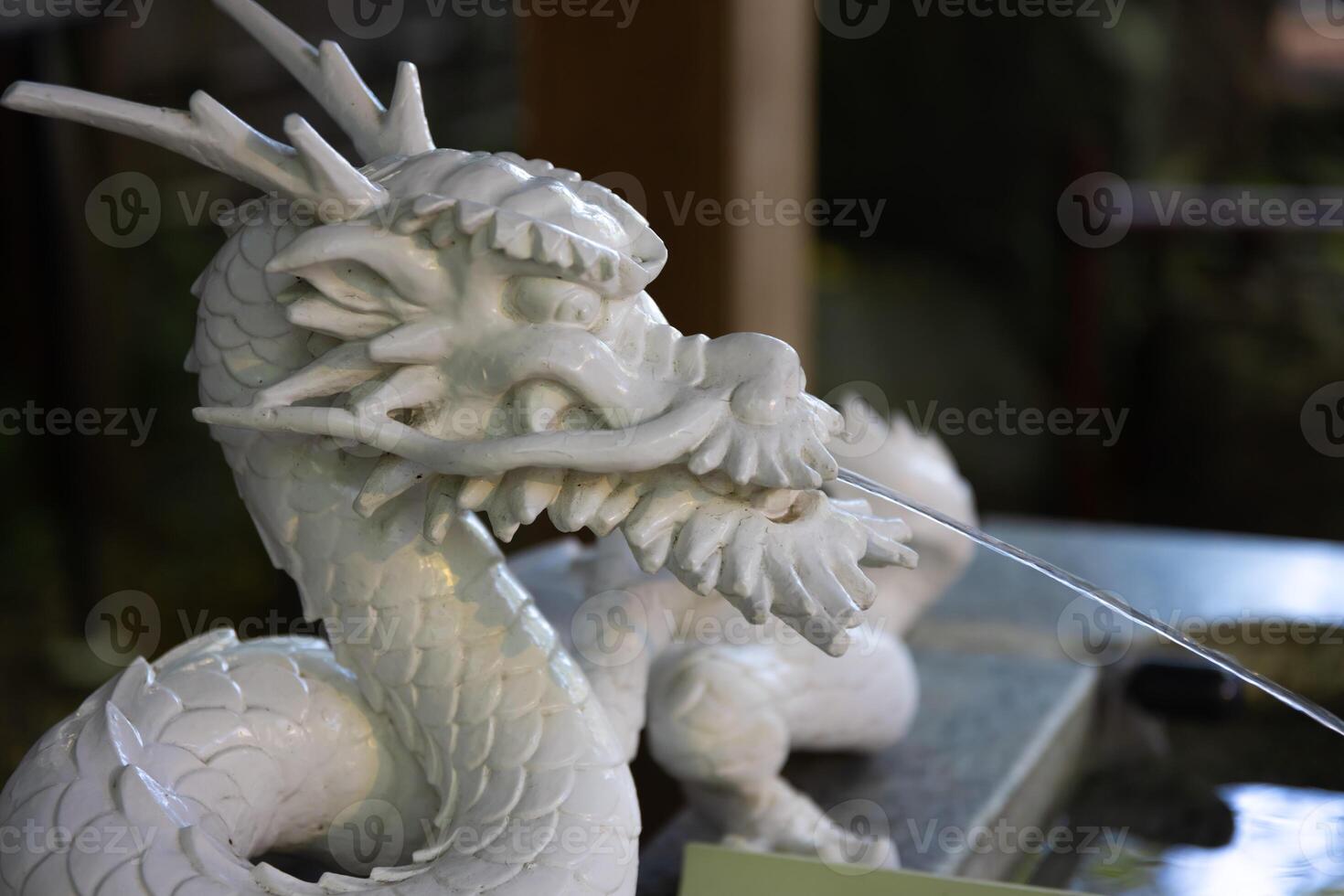 A statue of dragon at purification fountain in Japanese Shrine photo