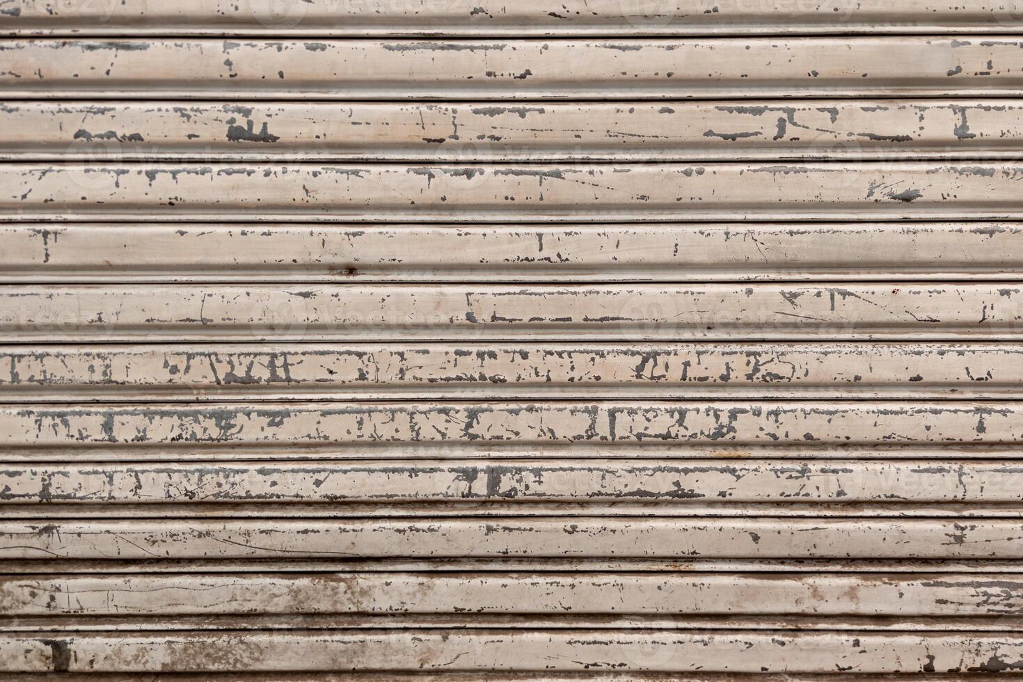 Closeup of a weathered metal shutter with horizontal folding lines photo
