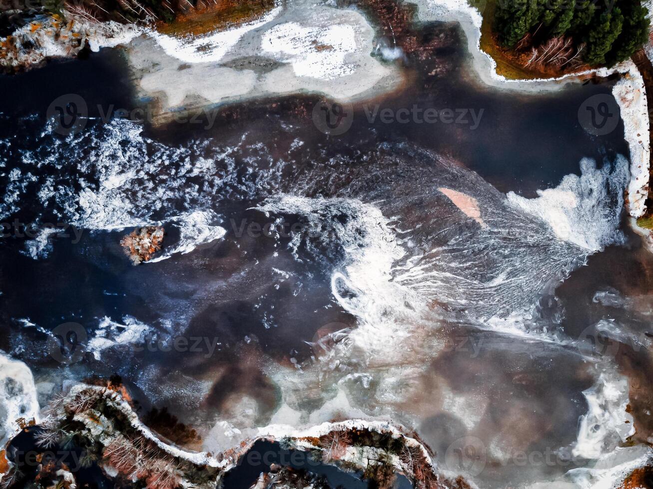 aero drone view of a flooded river during winter, showcasing the powerful and destructive forces of nature photo