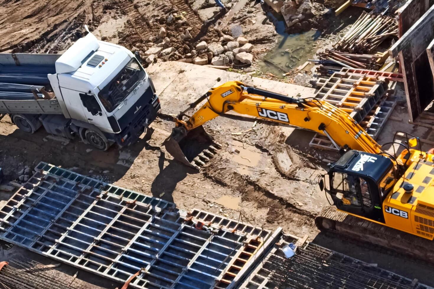 A truck and an excavator at a construction site. photo