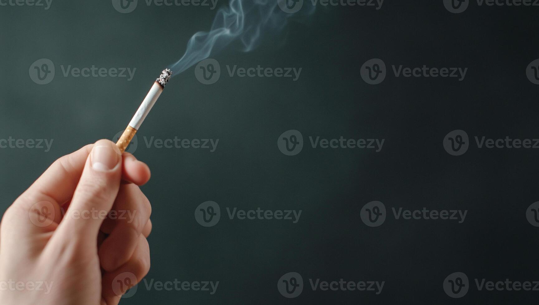 A person holding a cigarette in their hand photo