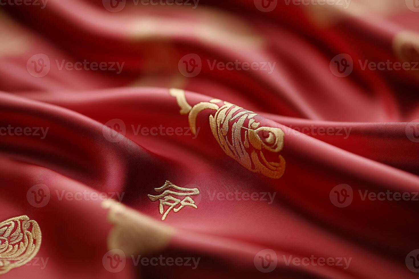 Close-up of red fabric adorned with gold patterns and symbols. photo