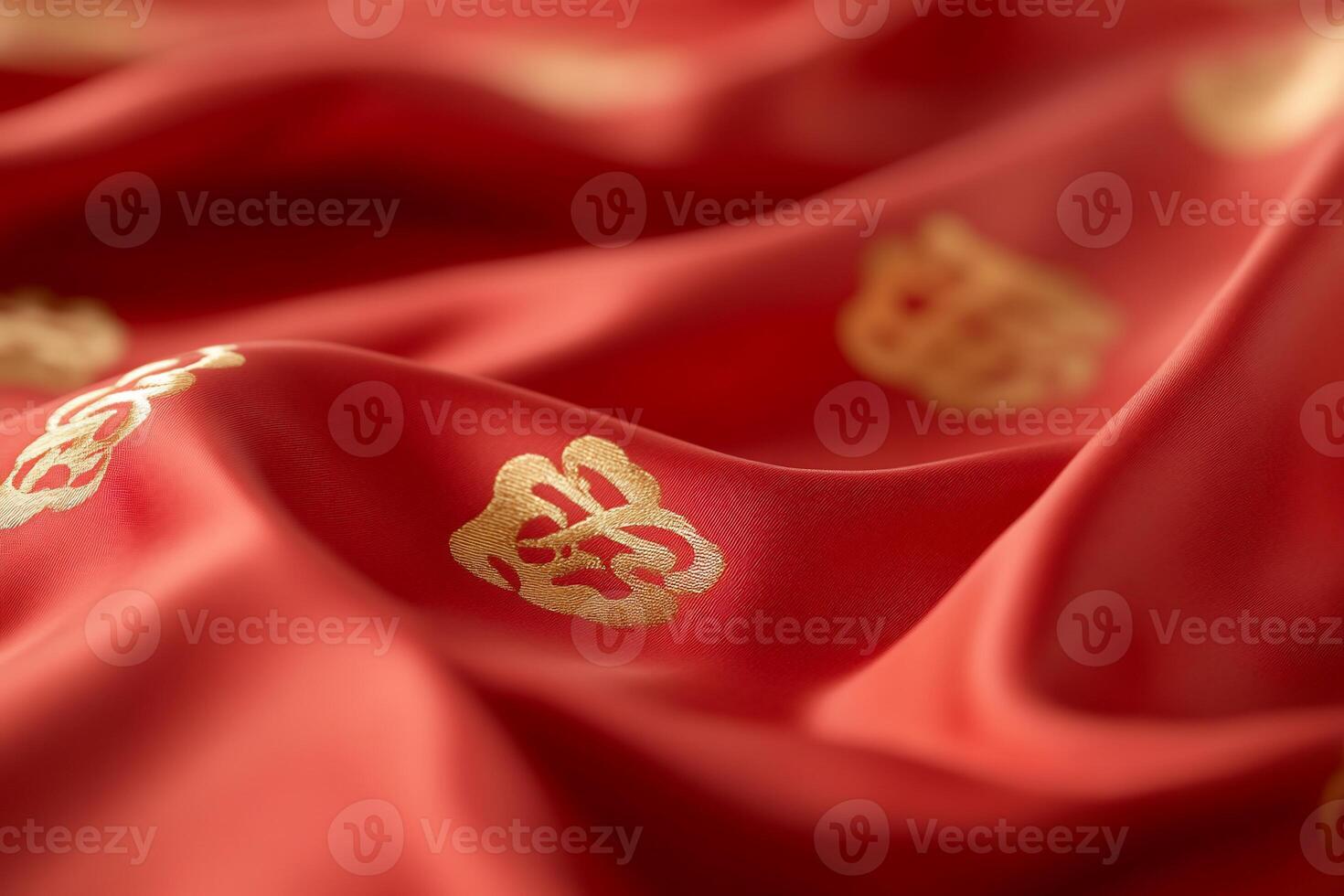 A close-up of luxurious red fabric with golden decorative patterns. photo