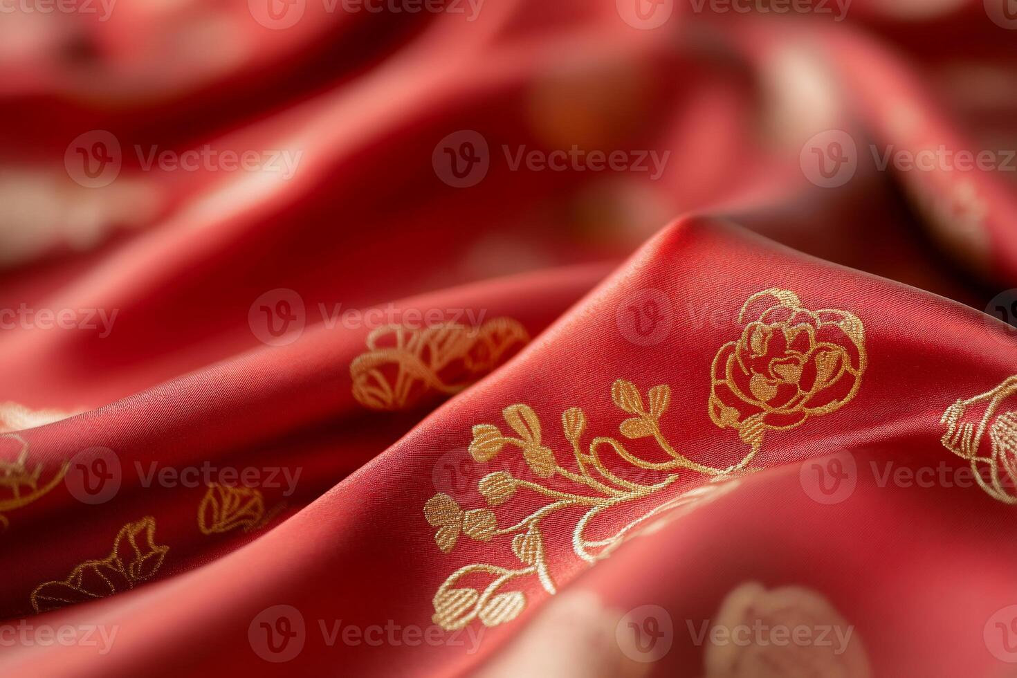 A close-up of luxurious red fabric with golden floral patterns. photo