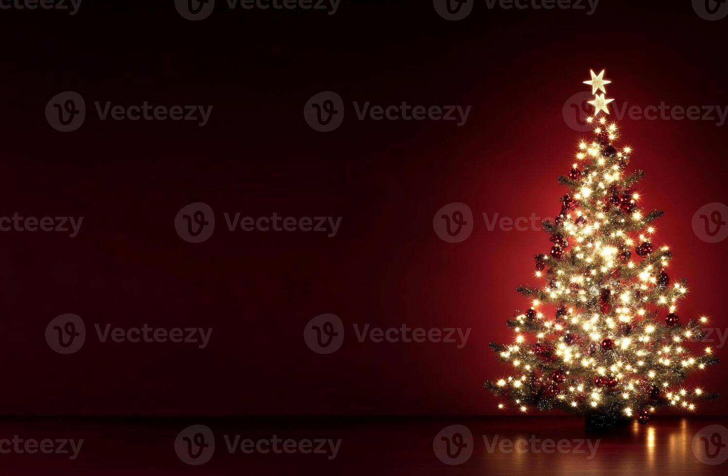 A beautifully decorated Christmas tree with lights against a red backdrop. photo