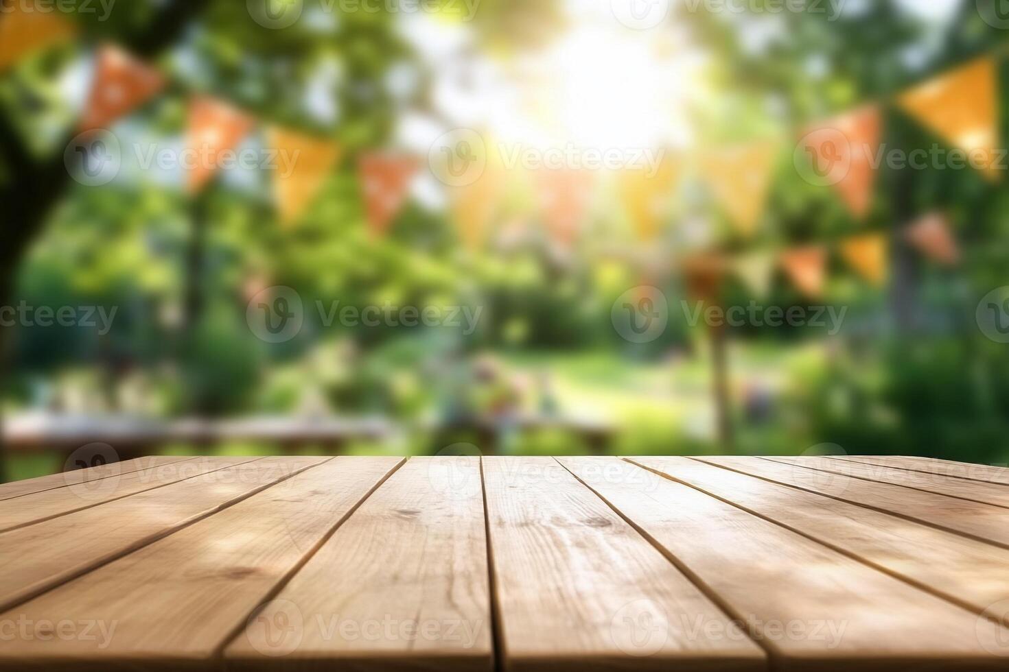 Wooden table top with blurred background in summer garden photo