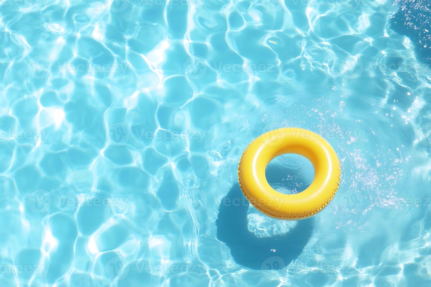 A bright yellow pool float in clear blue water, inviting relaxation. photo