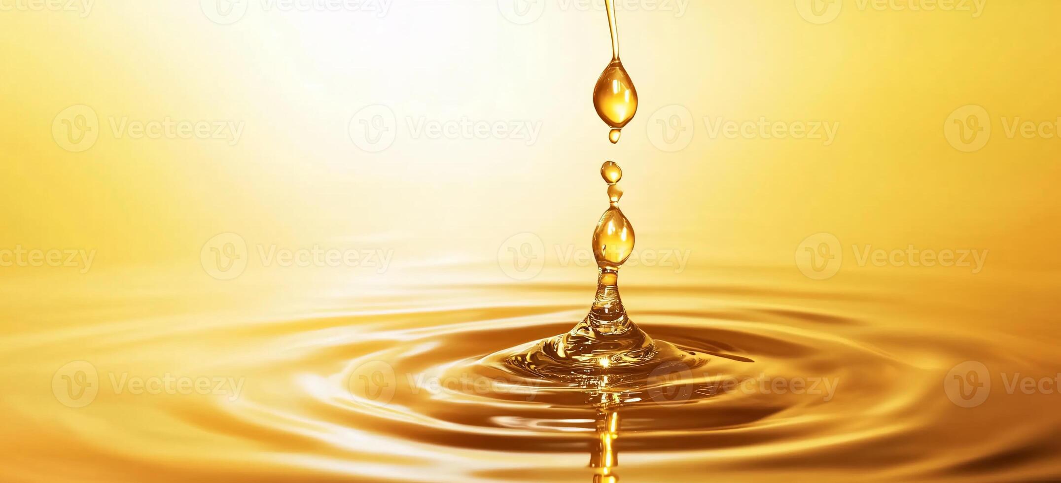 A close-up of a golden liquid drop creating ripples in water. photo