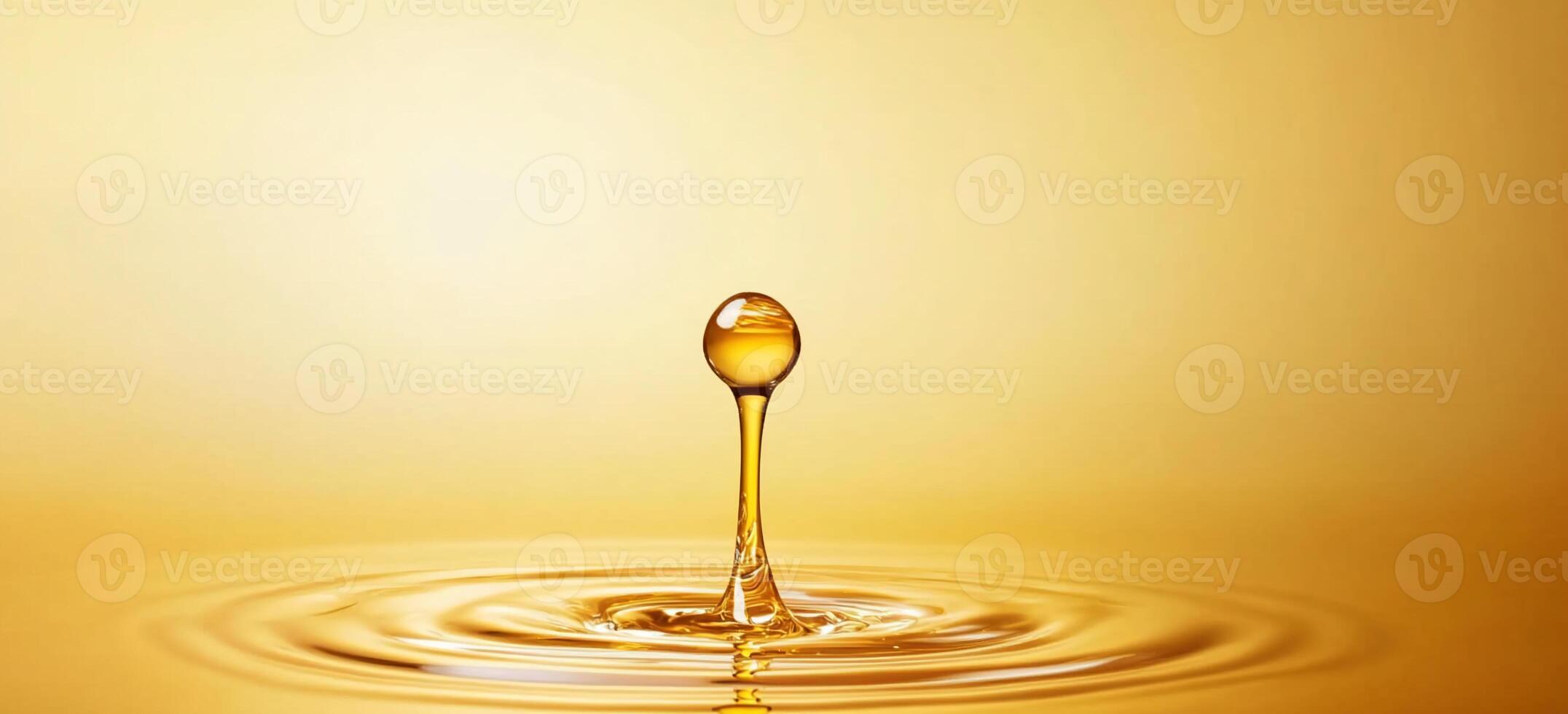 A droplet of liquid creates ripples on a golden surface. photo