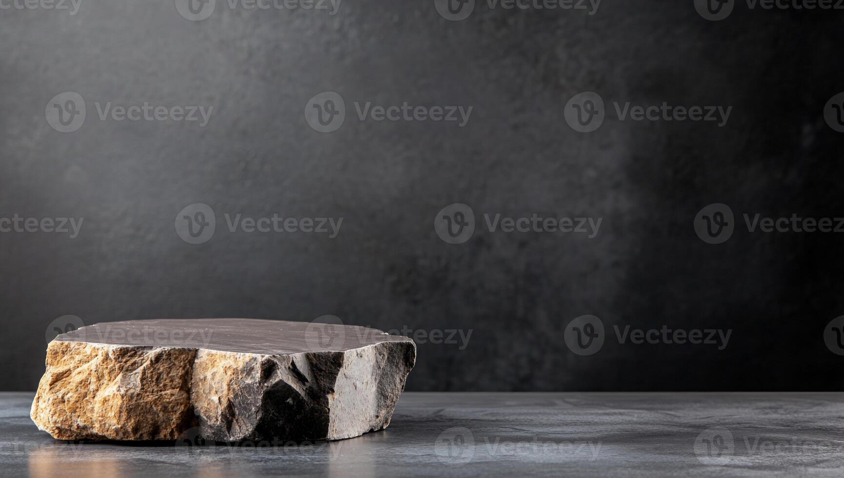 A smooth stone slab on a dark background, emphasizing texture. photo
