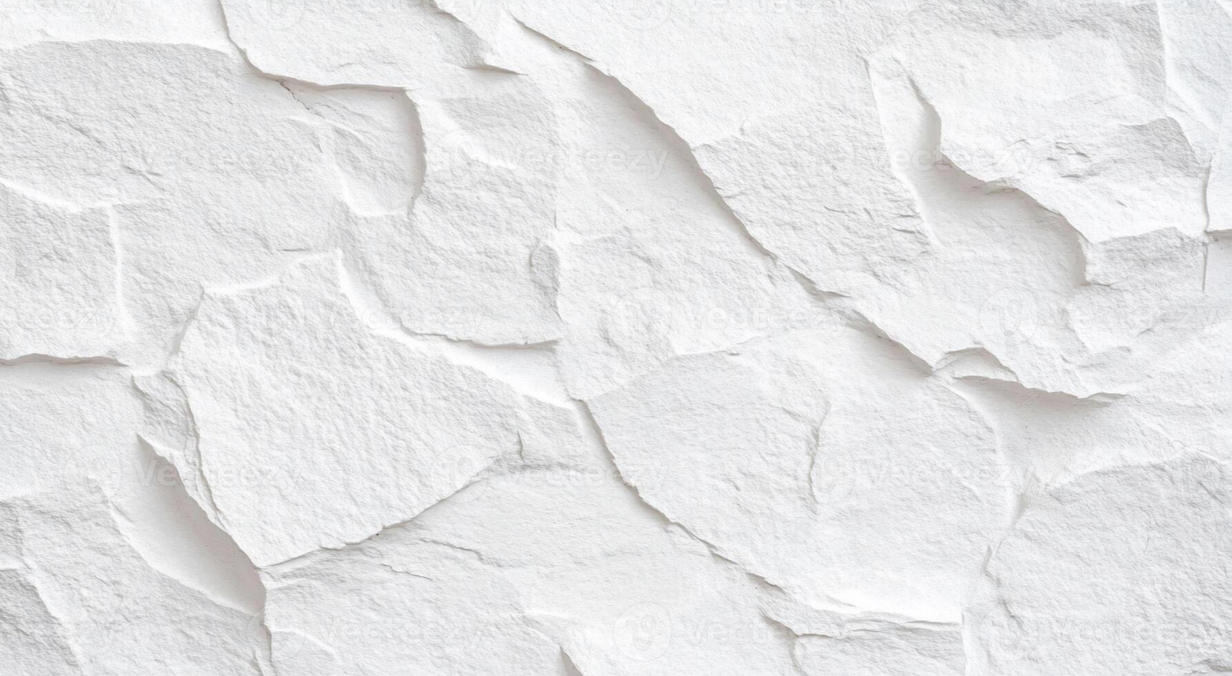 A textured white wall featuring irregular, layered patterns. photo