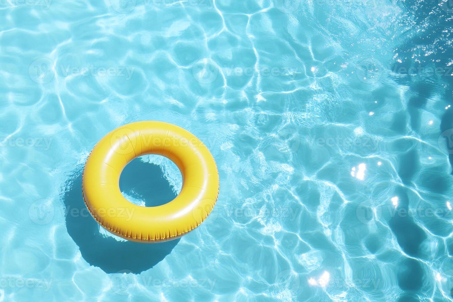 A vibrant yellow pool float in a clear blue swimming pool. photo