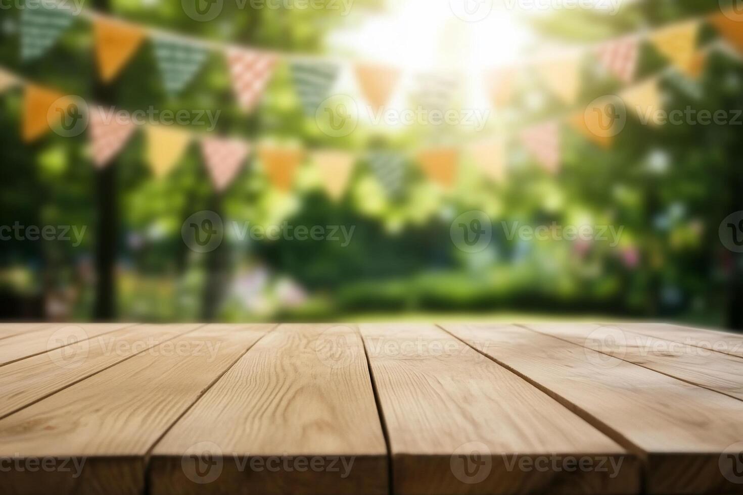 A wooden table in a sunny park setting with festive bunting. photo