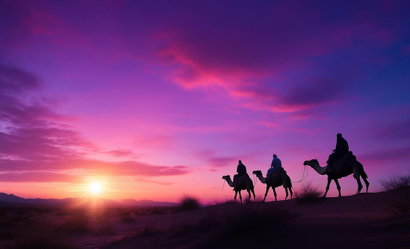 Three people riding camels at sunset photo