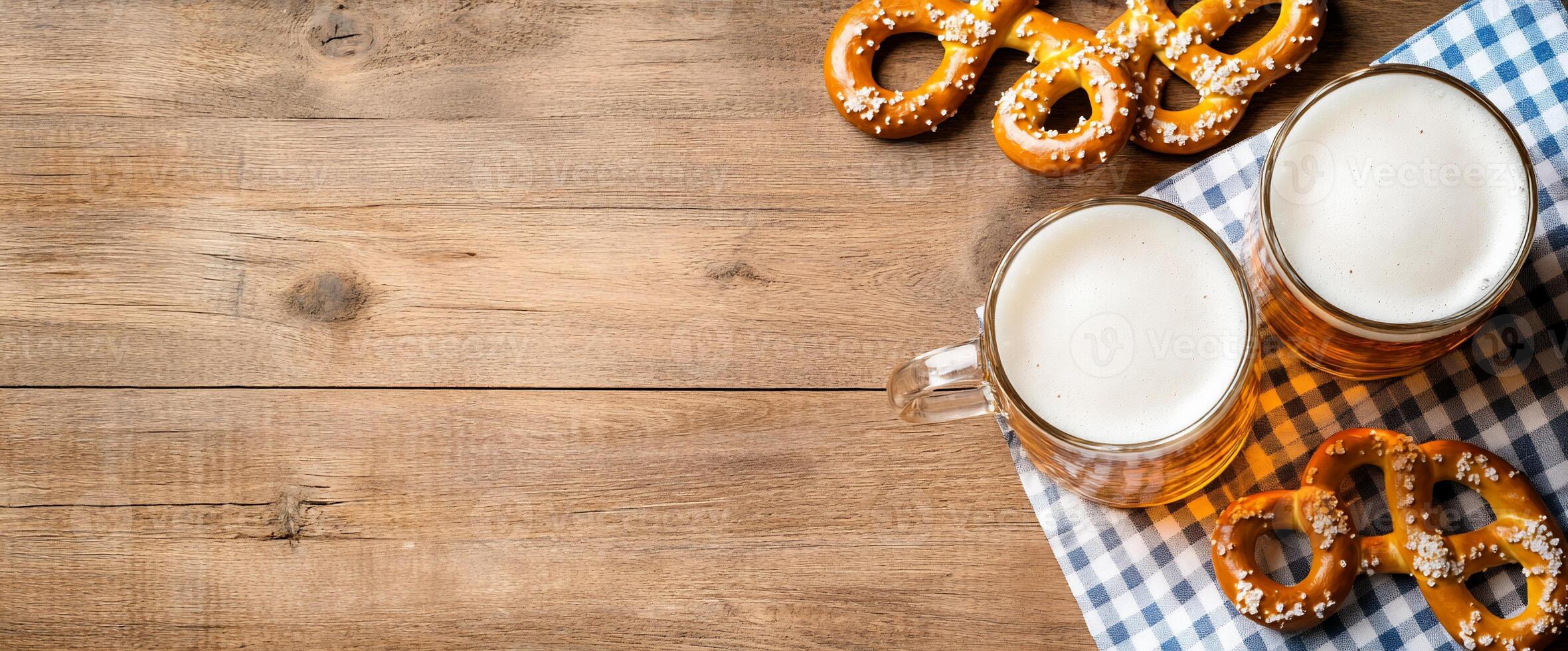 Two glasses of beer with pretzels on a checkered napkin. photo