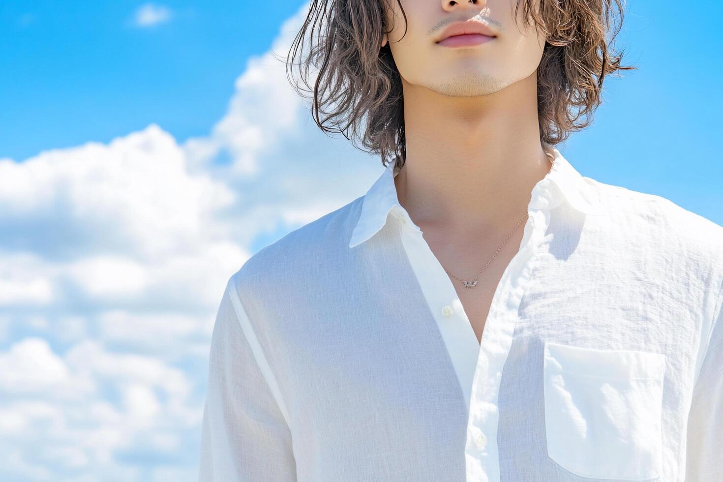 A man with long hair and a white shirt photo