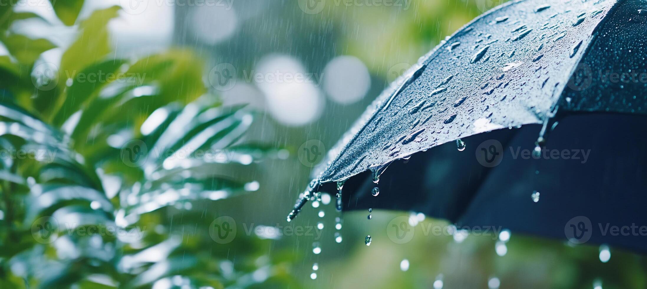 An umbrella is open in the rain with water droplets photo
