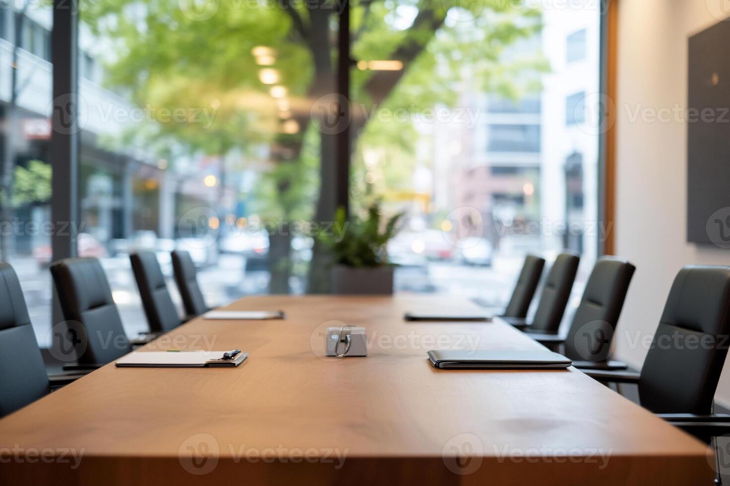 Modern conference room with a large table and chairs facing windows. photo