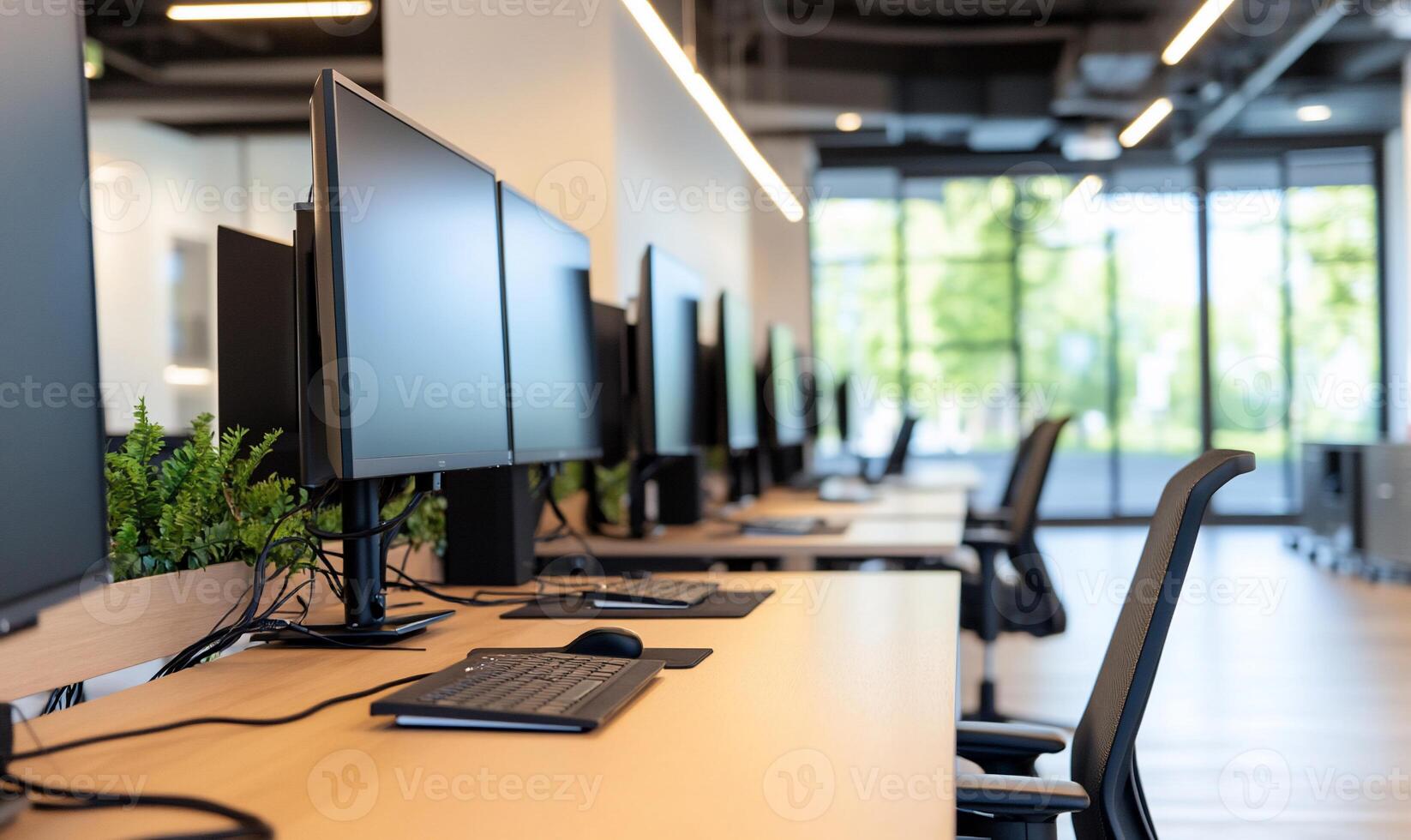 Modern office workspace with computers and ergonomic chairs. photo