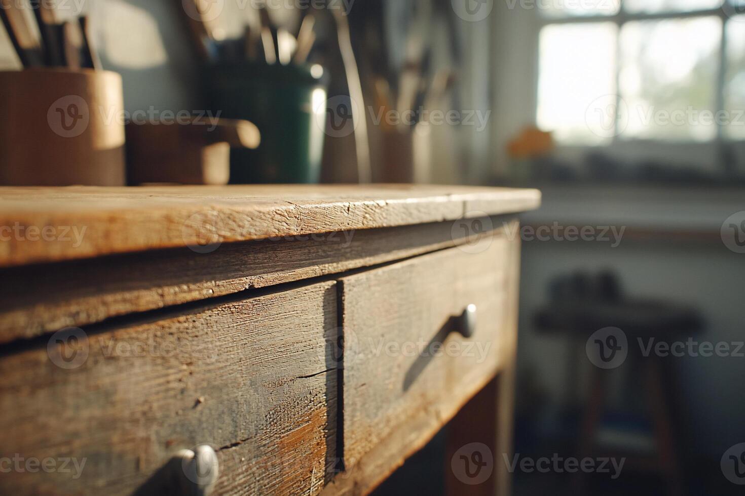 A close-up of a rustic wooden workbench in a workshop setting. photo
