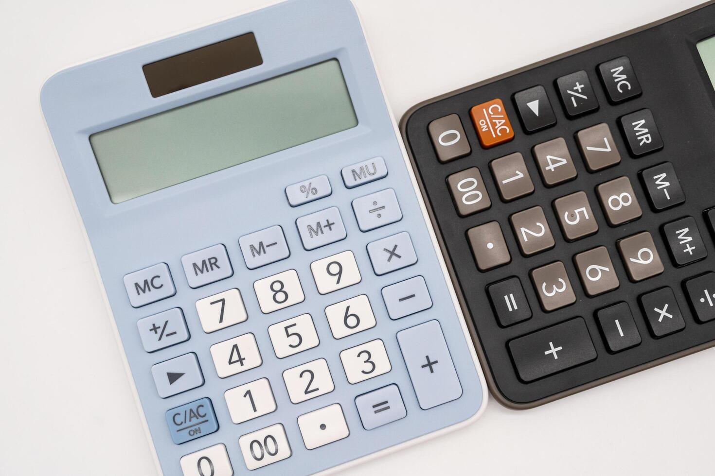 Light blue and black digital calculators on isolated background. Device for calculating the numbers. photo