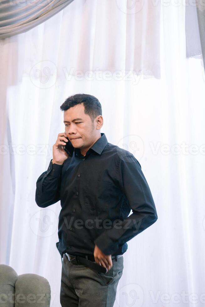 Concerned businessman answers call at home, potentially receiving bad news photo