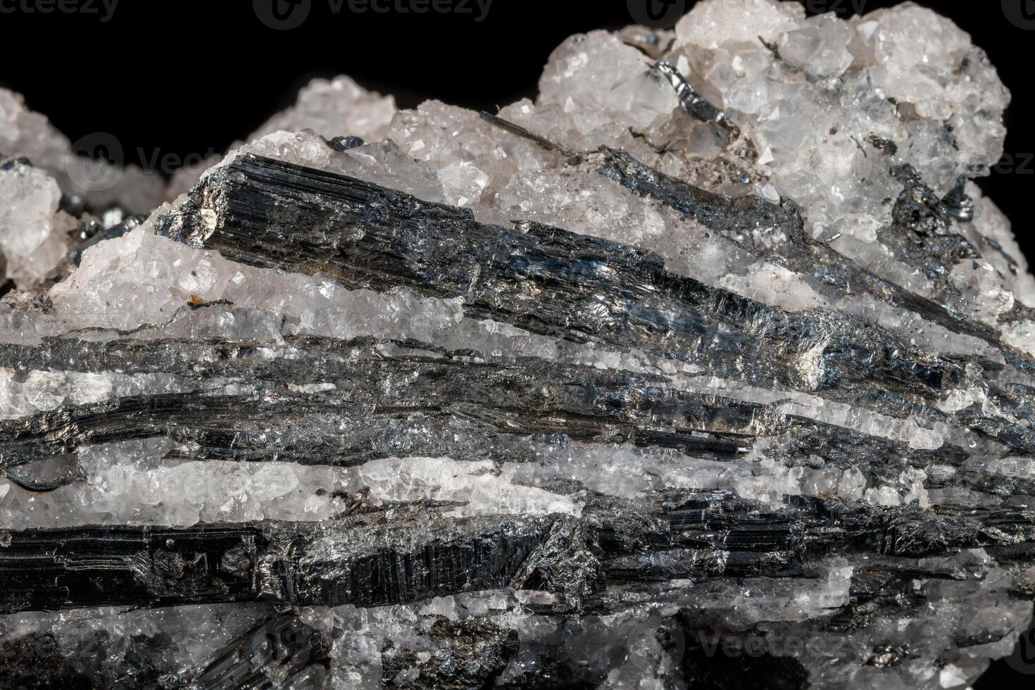 Macro mineral close up stone Stibnite quartz on a black background photo