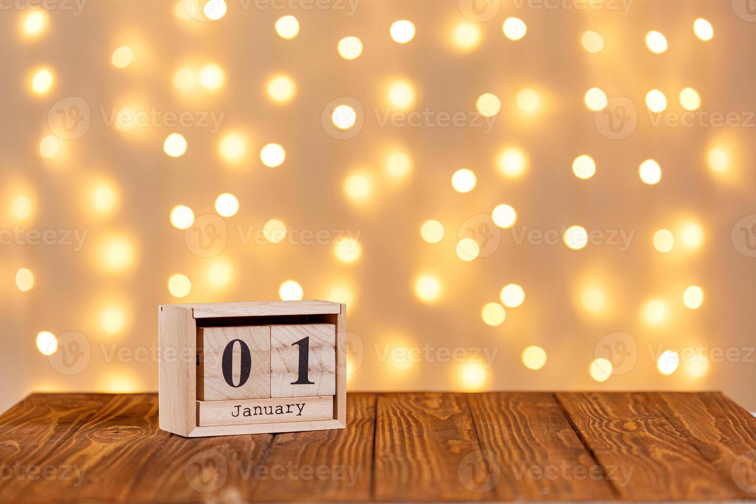 new year, wooden calendar january 1 on wooden background and lights background photo