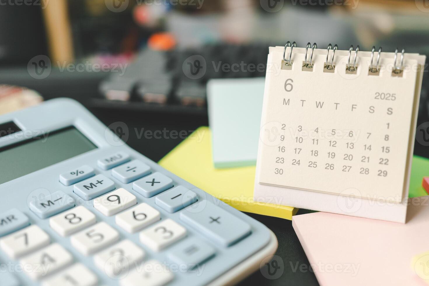 Desk calendar for JUNE 2025 with Sticky note. Calendar concept with 2025 JUN calendar. calculator and forecast for finances in 2025. Money, Budget, tax, investment and financial. photo