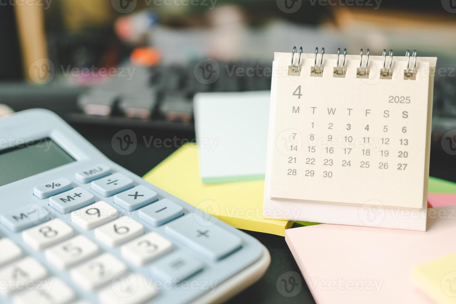 Desk calendar for APRIL 2025 with Sticky note. Calendar concept with 2025 APR calendar. calculator and forecast for finances in 2025. Money, Budget, tax, investment and financial. photo