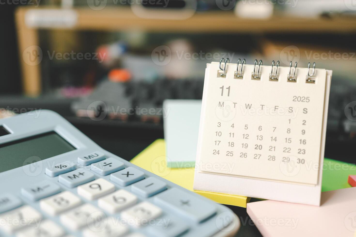Desk calendar for NOVEMBER 2025 with Sticky note. Calendar concept with 2025 NOV calendar. calculator and forecast for finances in 2025. Money, Budget, tax, investment and financial. photo