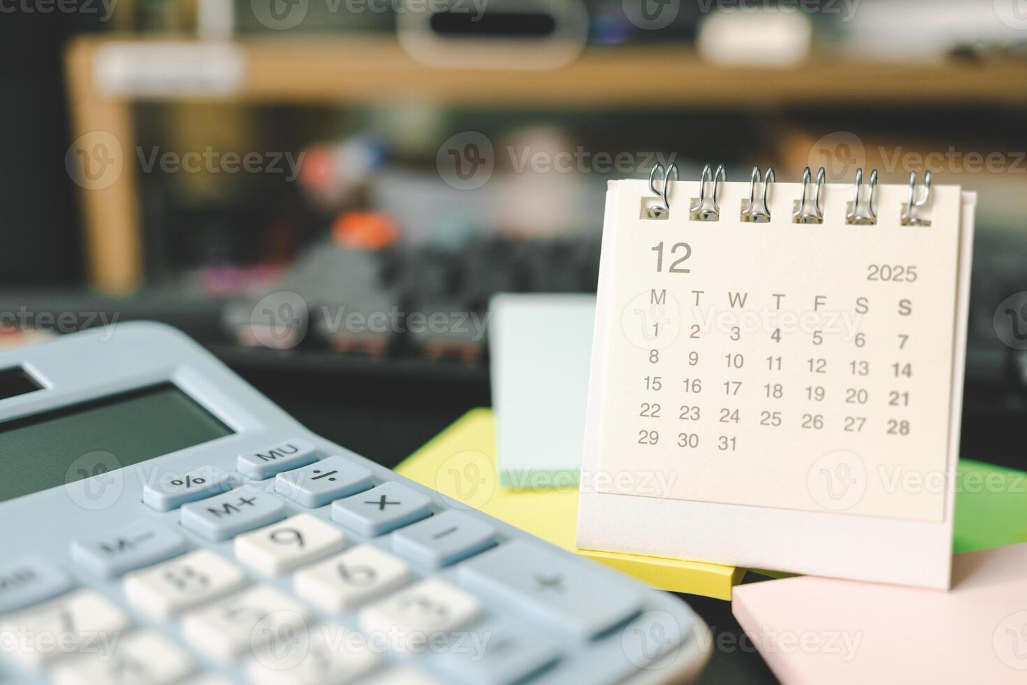 Desk calendar for DECEMBER 2025 with Sticky note. Calendar concept with 2025 DEC calendar. calculator and forecast for finances in 2025. Money, Budget, tax, investment and financial. photo