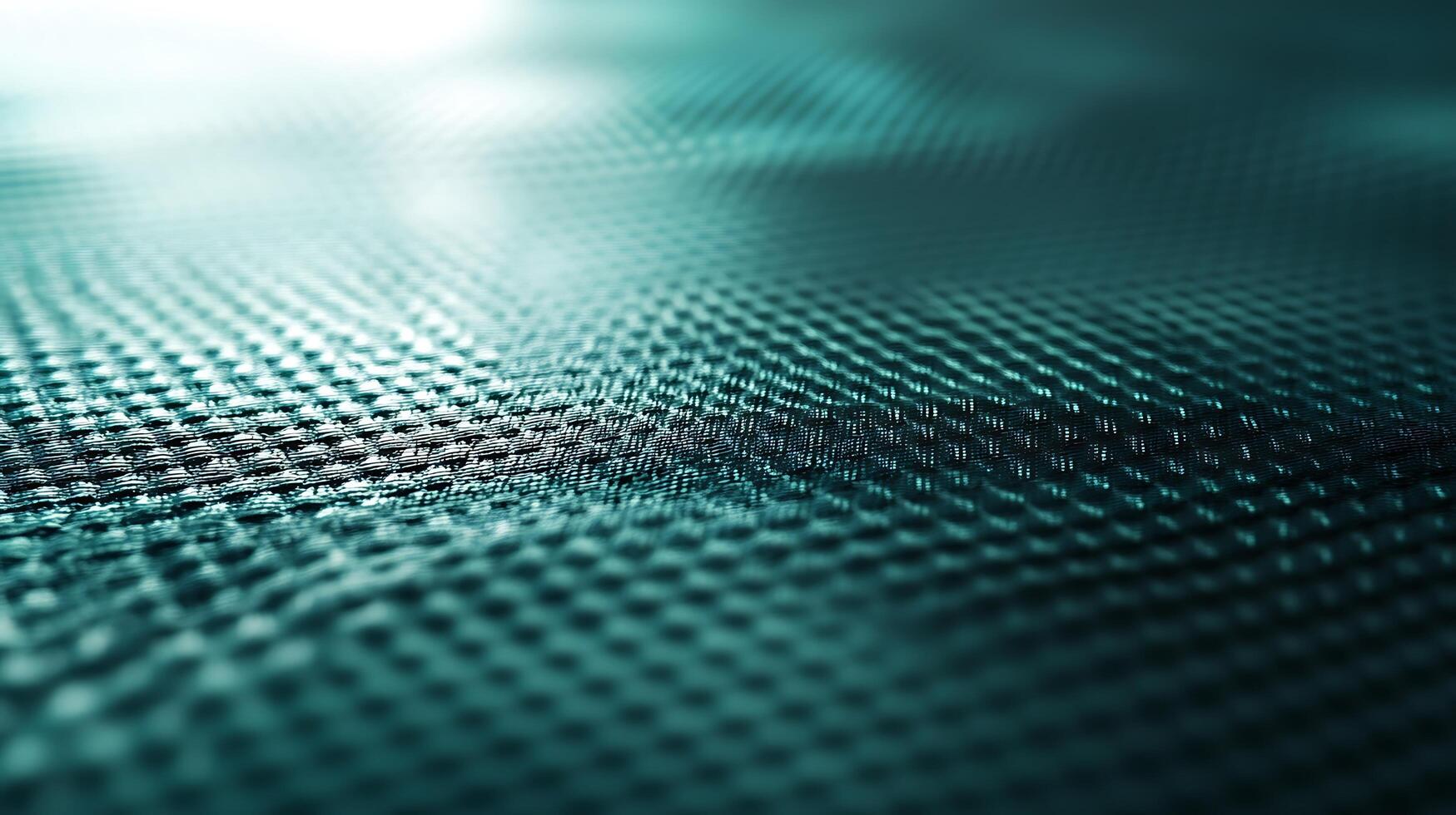 A textured surface with a patterned design, featuring a weave-like structure with a gradient teal color scheme and shallow depth of field. photo