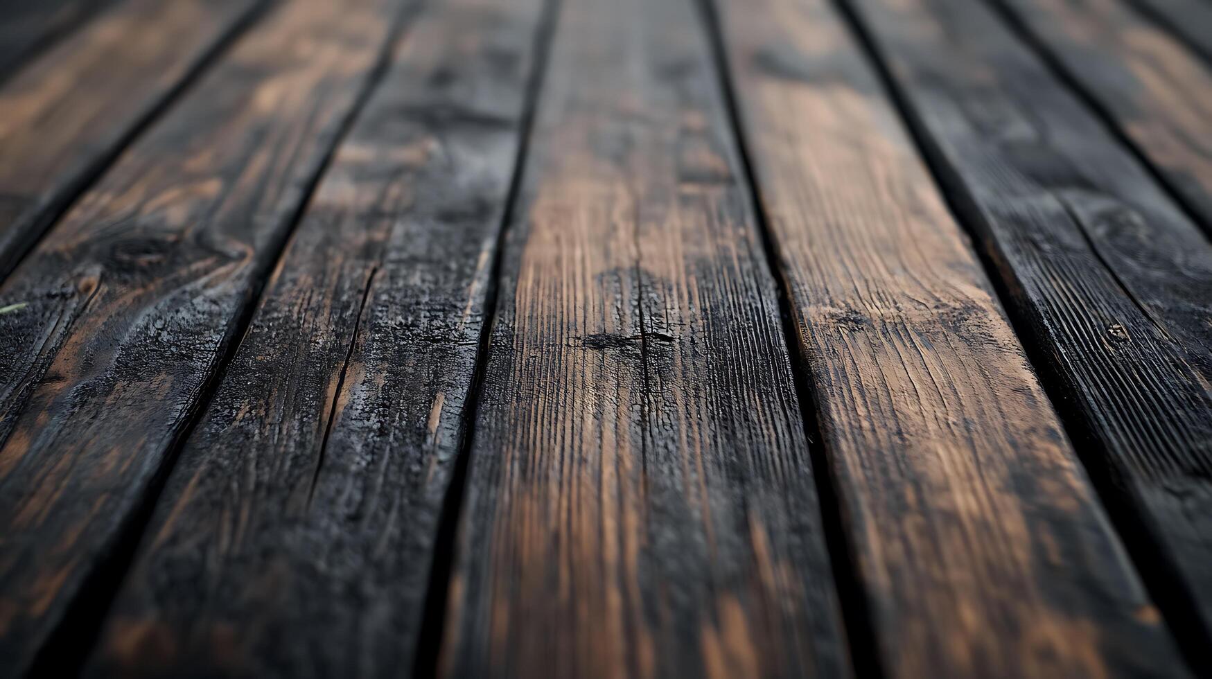 Dark wooden planks with distressed finish. Rustic, textured surface. Shallow depth of field for a blurred perspective. photo
