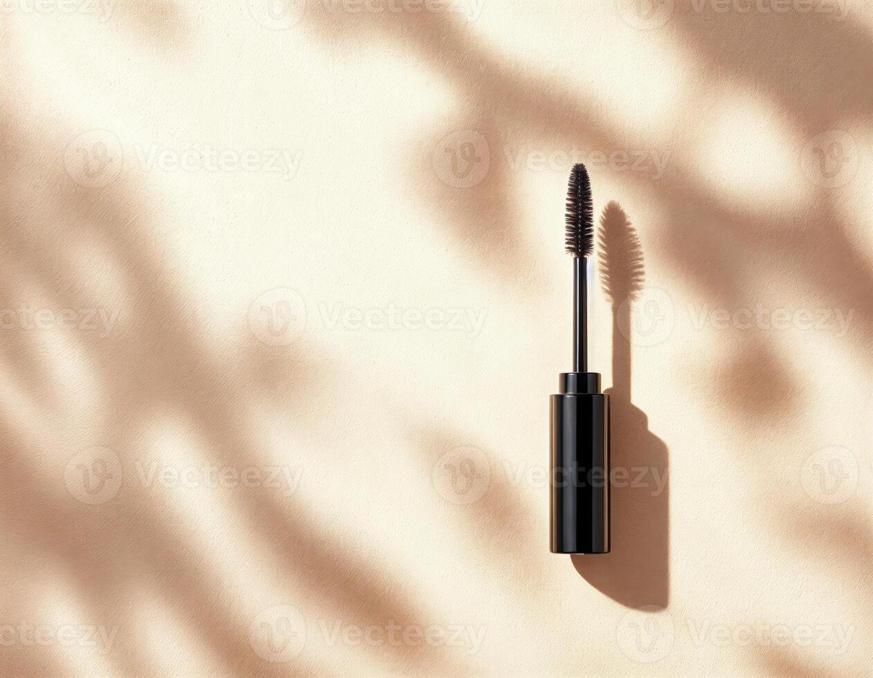 Mascara on a beige background with shadows. Flat lay, top view. Black Mascara Product Shot photo