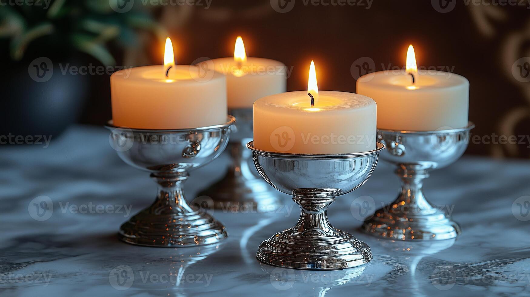 Four candles are lit in silver goblets photo