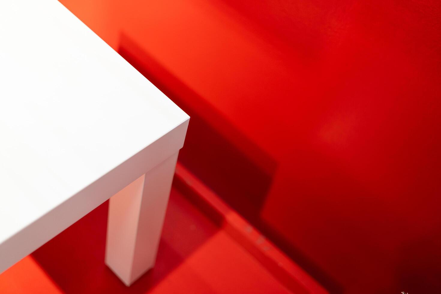 Part of white chair or table on red background. photo