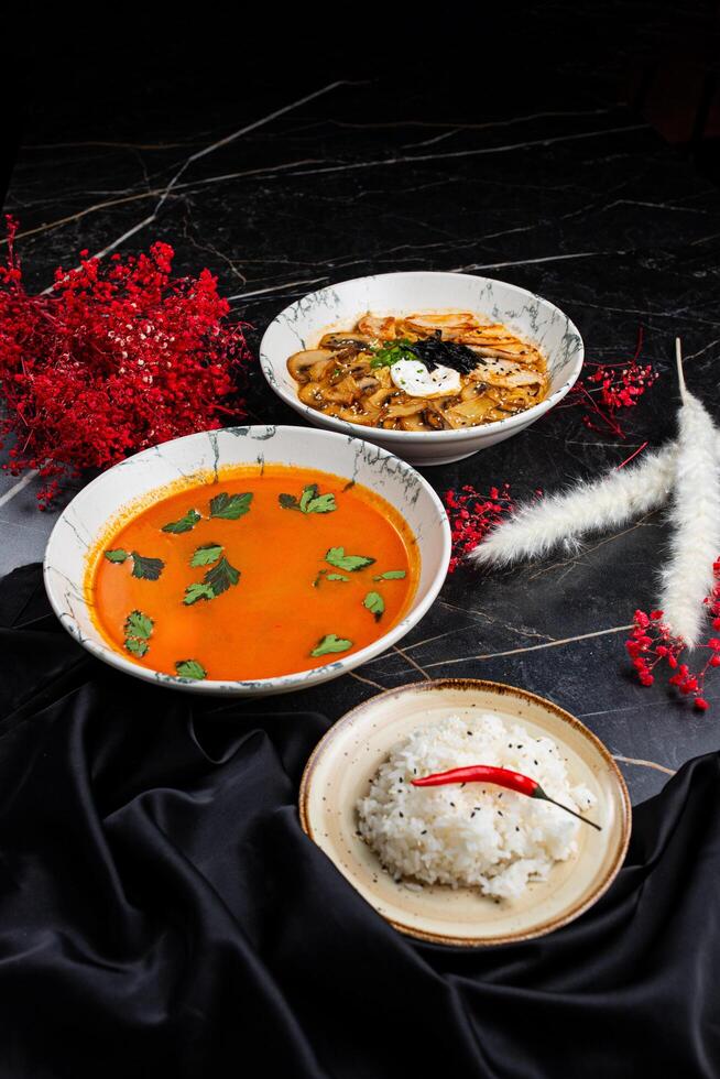 A table with two plates of food and a bowl of rice photo