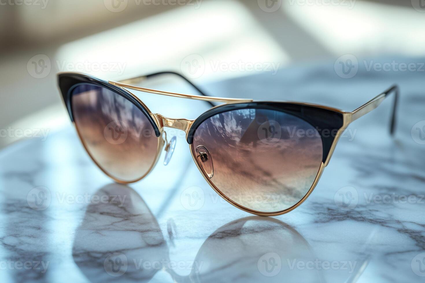 Cat eye sunglasses resting on marble surface reflecting sky photo