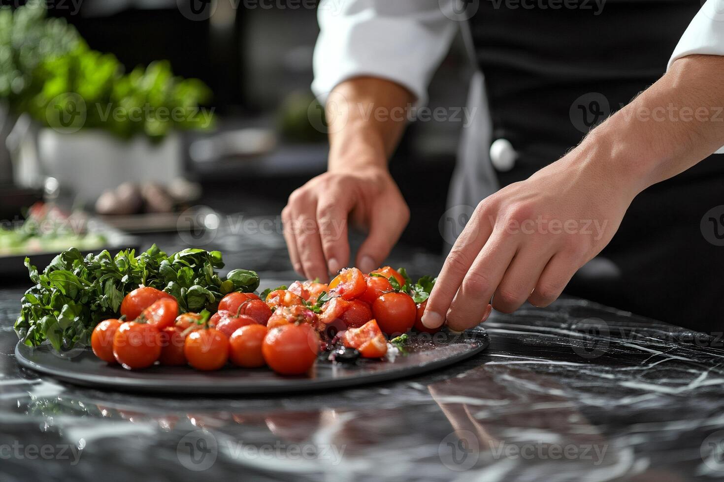 Chef arranging delicious cherry tomatoes and fresh herbs on a plate photo