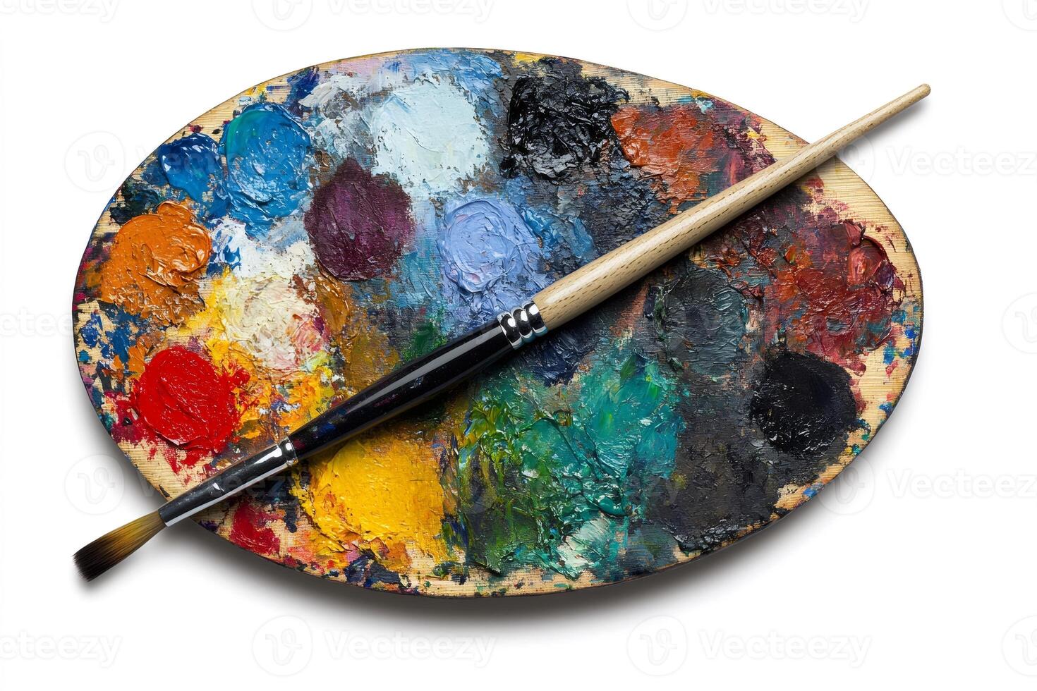 Paintbrush resting on an artist's palette covered in colorful oil paints photo