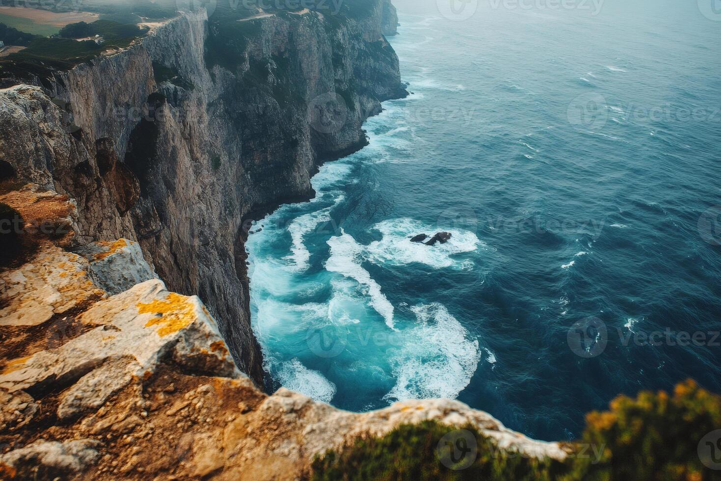Ocean waves crashing on rocky cliffs in a dramatic coastal landscape photo