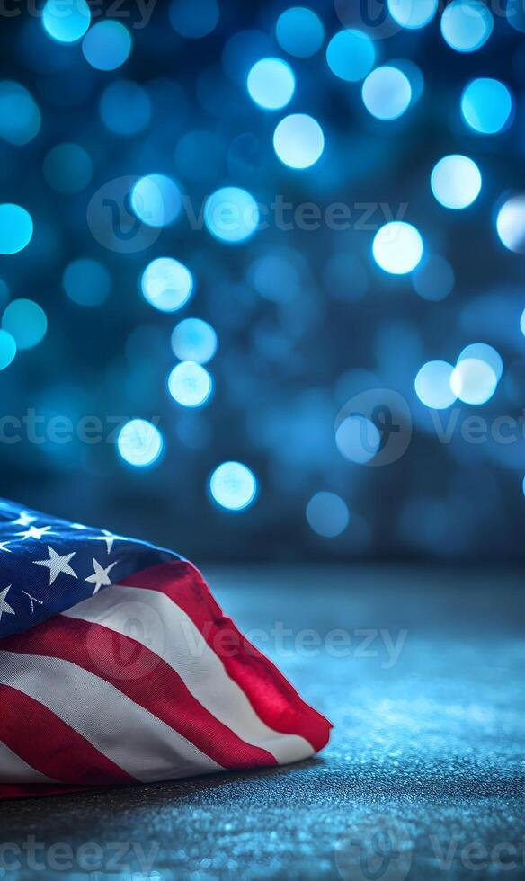 Patriotic tribute american flag in subdued lighting with abstract sparkling blue background photo