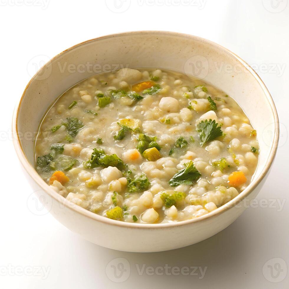 A bowl of soup with vegetables and greens photo