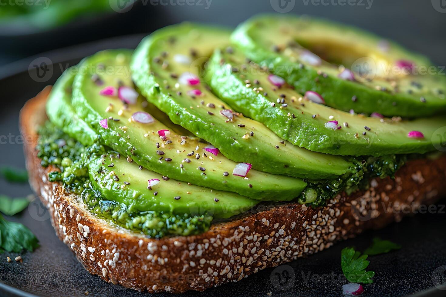 Healthy Avocado Toast with Pesto and Red Onion on Whole Grain Bread for Breakfast photo