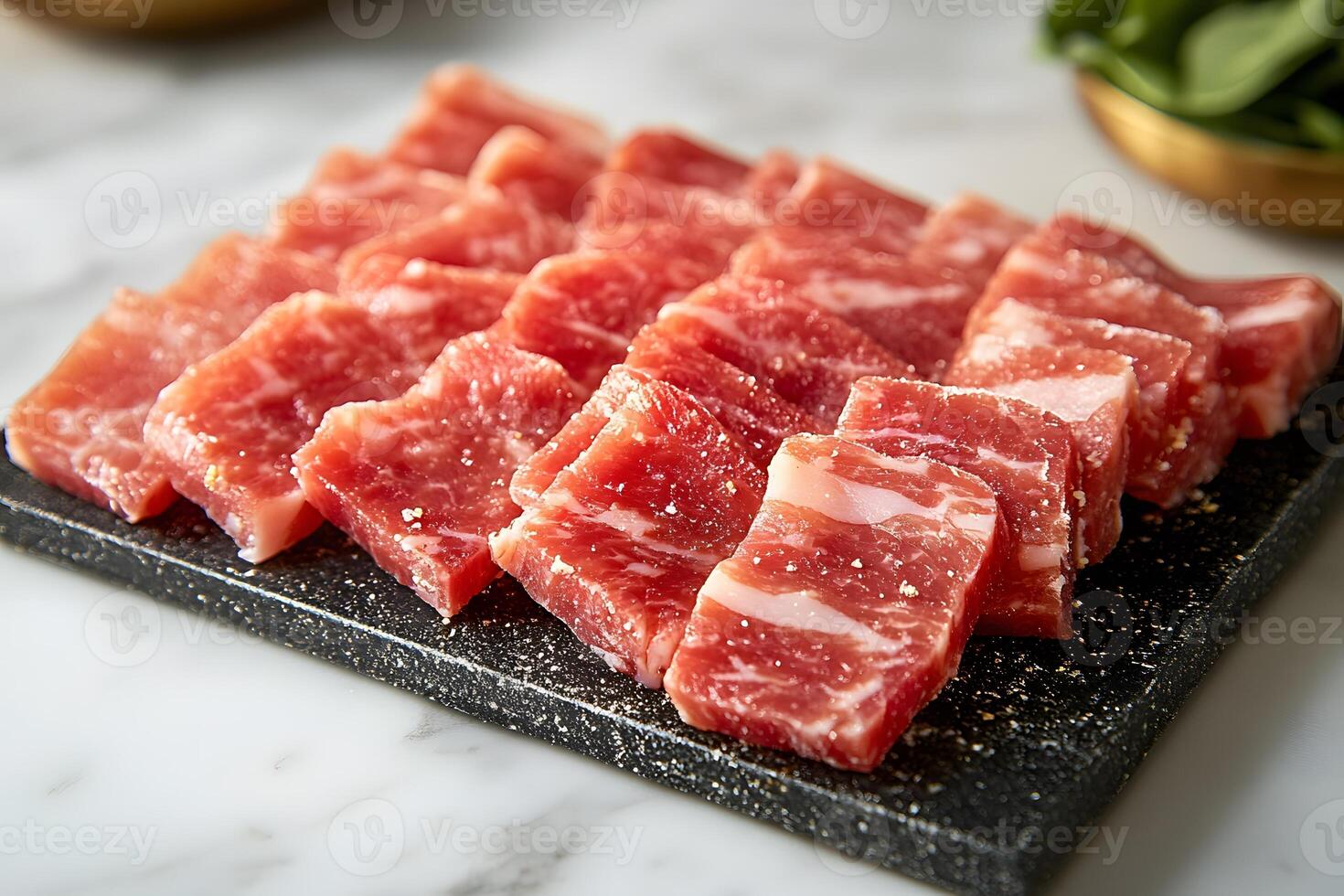 Fresh Raw Marbled Pork Belly Slices on Black Cutting Board for Culinary Preparation photo