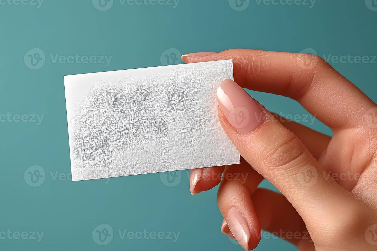 Blank Business Card Held by Hand Against Teal Background for Branding and Design photo