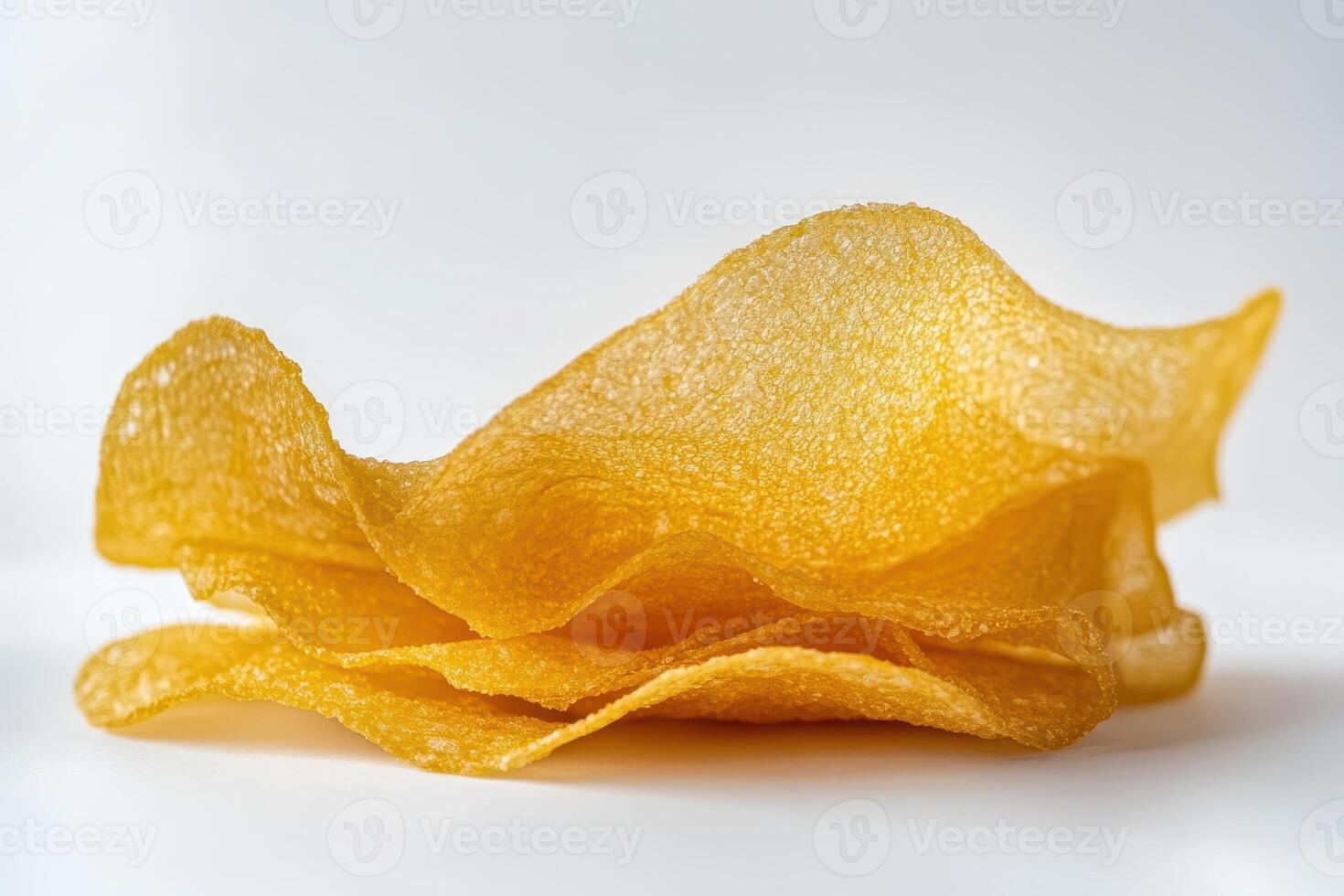 A stack of golden, crispy snacks with a wavy texture. photo