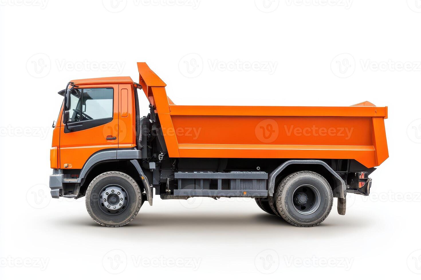 A side view of an orange dump truck designed for transporting materials. photo