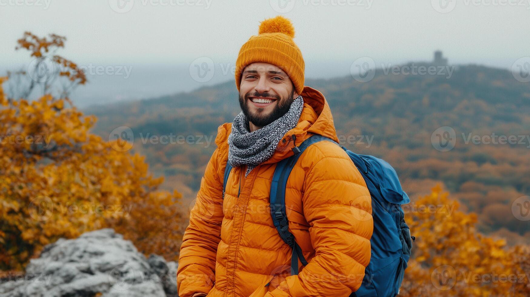 Happy Man Hiking in Autumn Mountain Landscape Wearing Orange Jacket Backpack photo